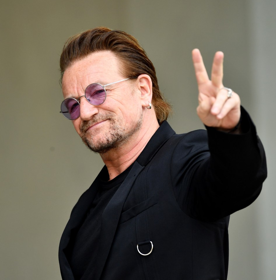 Bono giving the peace sign.