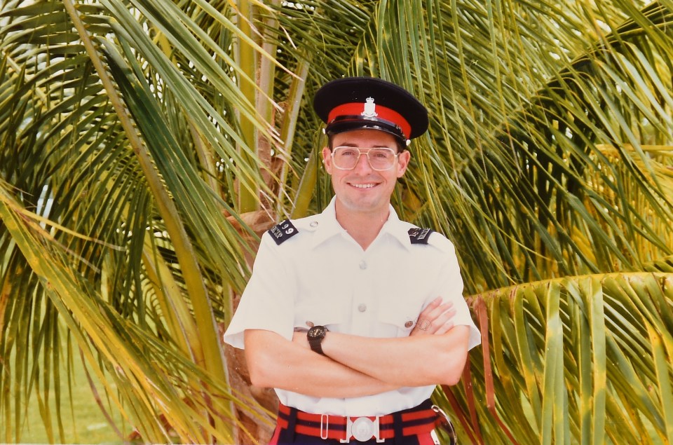 Photograph of a police officer on a tropical beach.