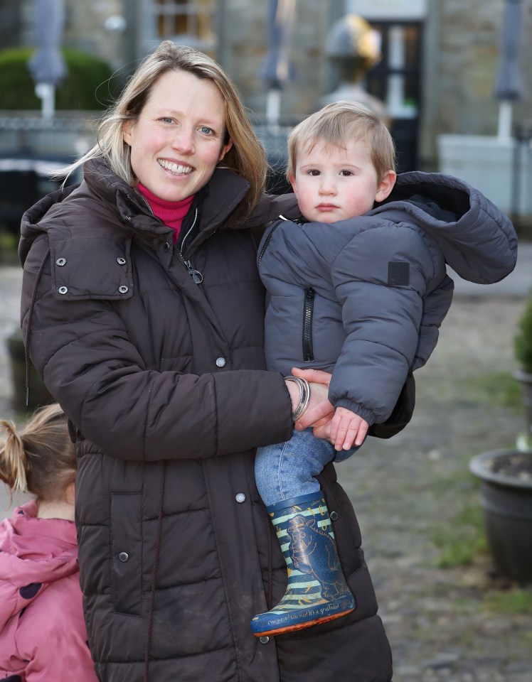 A woman holding a toddler.