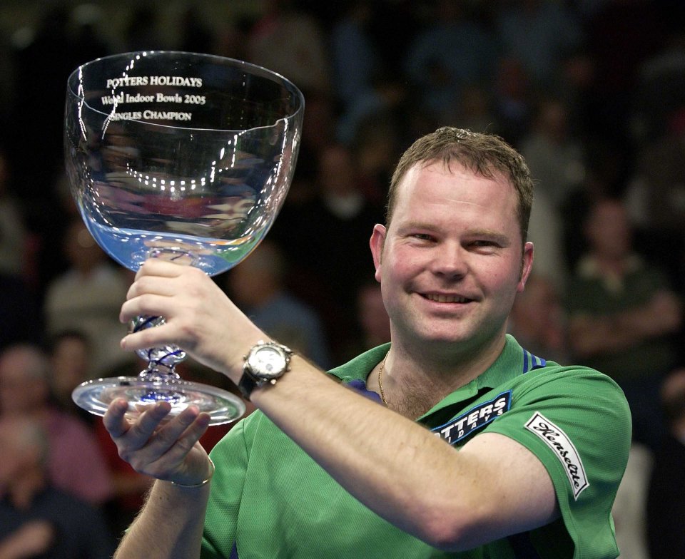 Paul Foster, the winner of the World Indoor Bowls Singles Championships, holding a trophy.