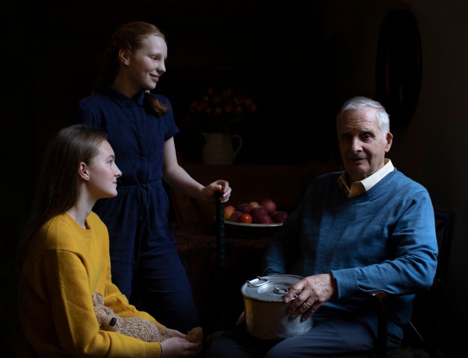 A Holocaust survivor with his granddaughters.