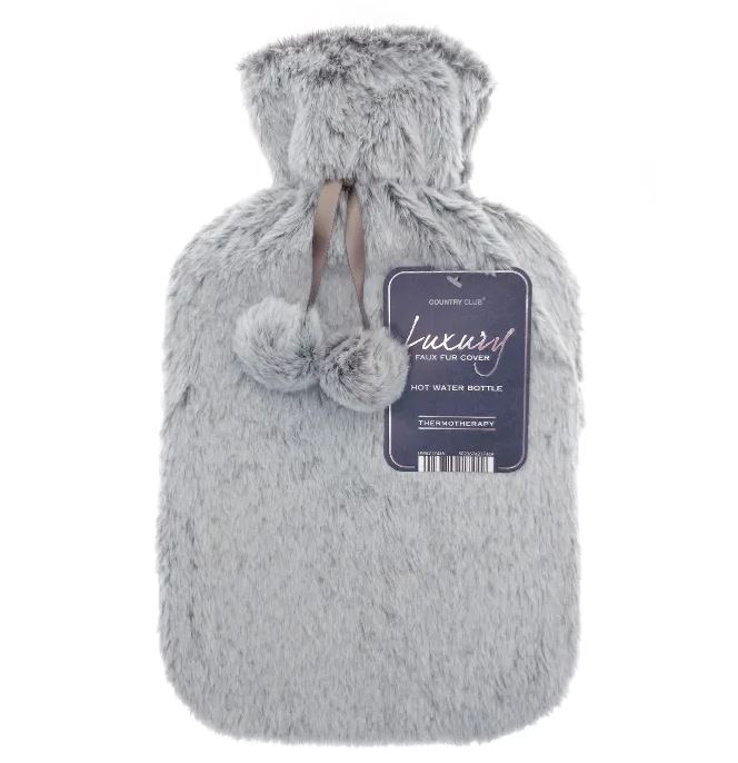 Grey faux fur hot water bottle with pom-poms.