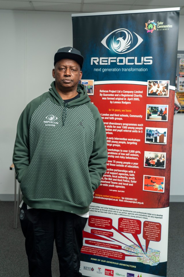 Photo of Josh Saunders, Refocus Manager, standing next to a promotional banner.