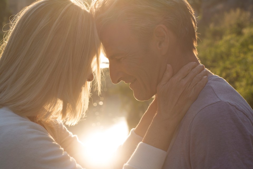 A couple embracing at sunrise.