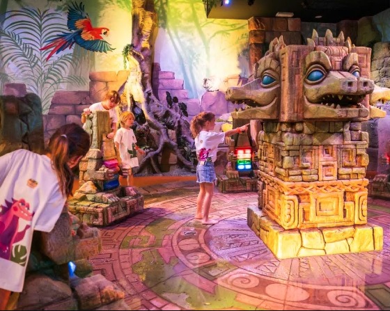 Children playing in a Crocodile Island themed play area.