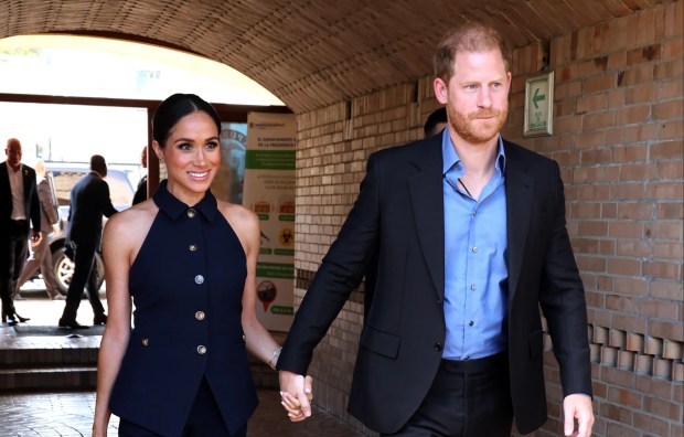 Prince Harry and Meghan Markle holding hands.