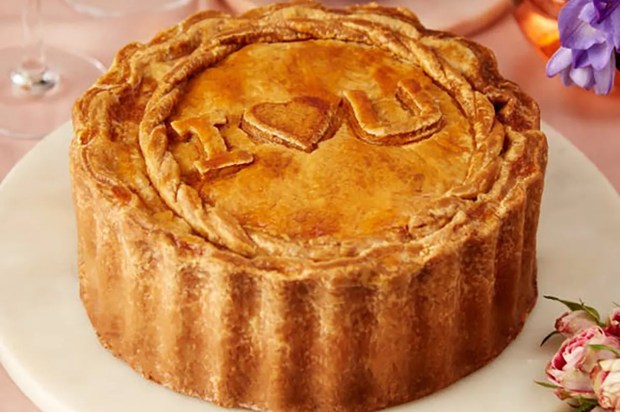 Large pork pie with &quot;I love you&quot; on top.