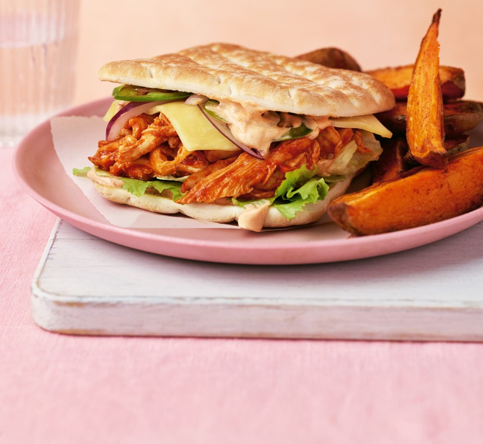 Chicken sandwich with sweet potato wedges.