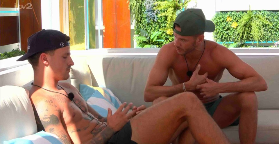 Scott Thomas and Luca Bish of Love Island having a conversation.