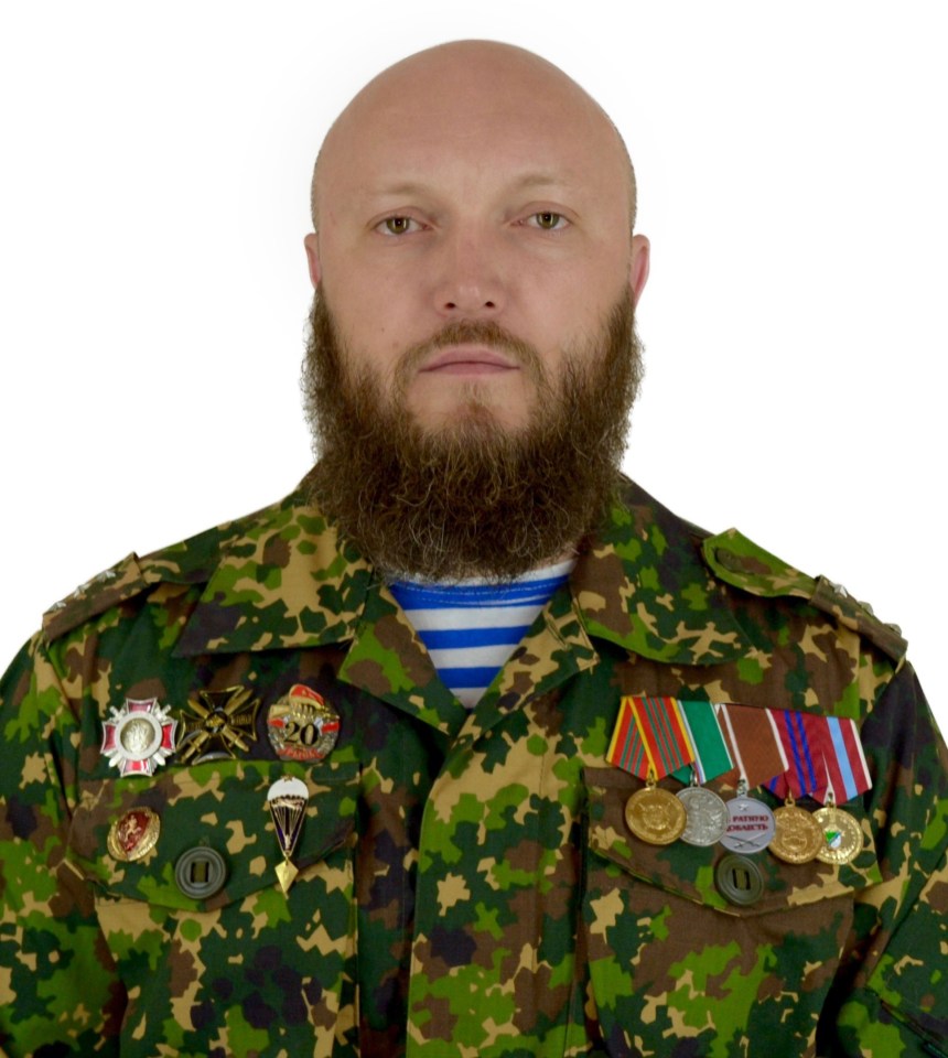 Portrait of Danil Shargan, head of a military sports center, wearing a camouflage uniform and medals.