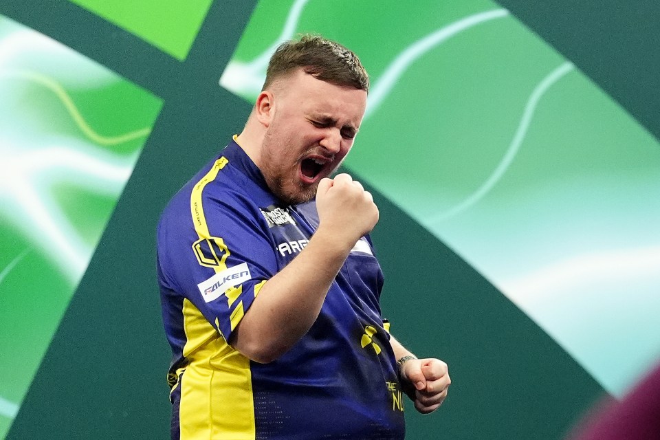 Luke Littler celebrates winning his World Darts Championship semi-final match.