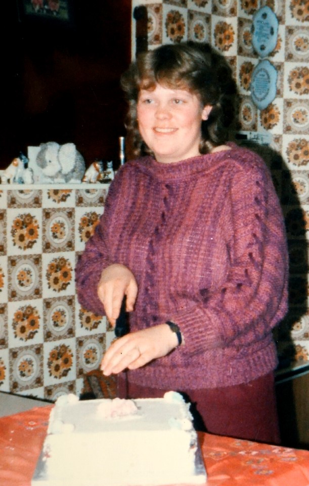 Photo of Debbie Griggs on her 21st birthday, cutting a cake.