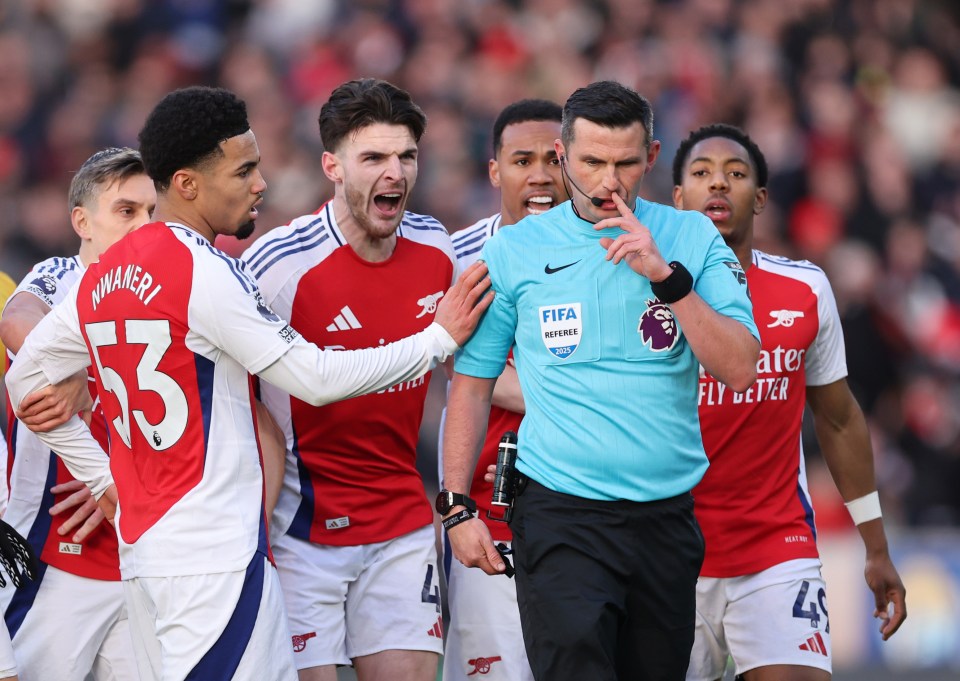 Arsenal players appeal to the referee after a red card.