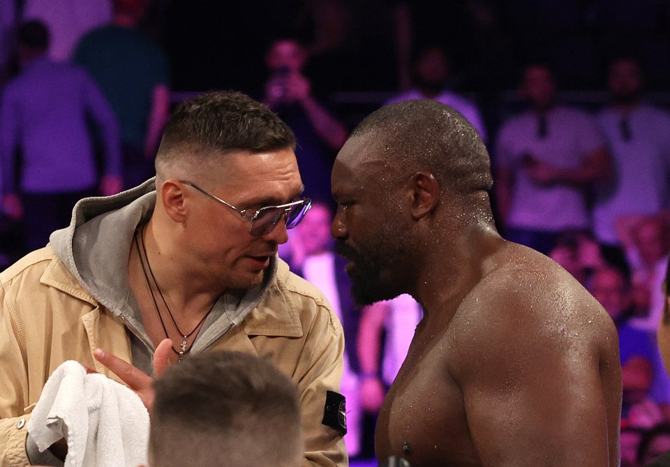 Oleksandr Usyk congratulates Derek Chisora after a boxing match.