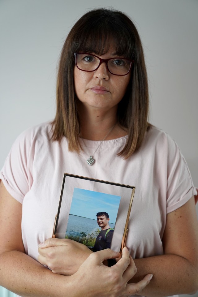 A mother holds a picture of her son who died from ketamine addiction.