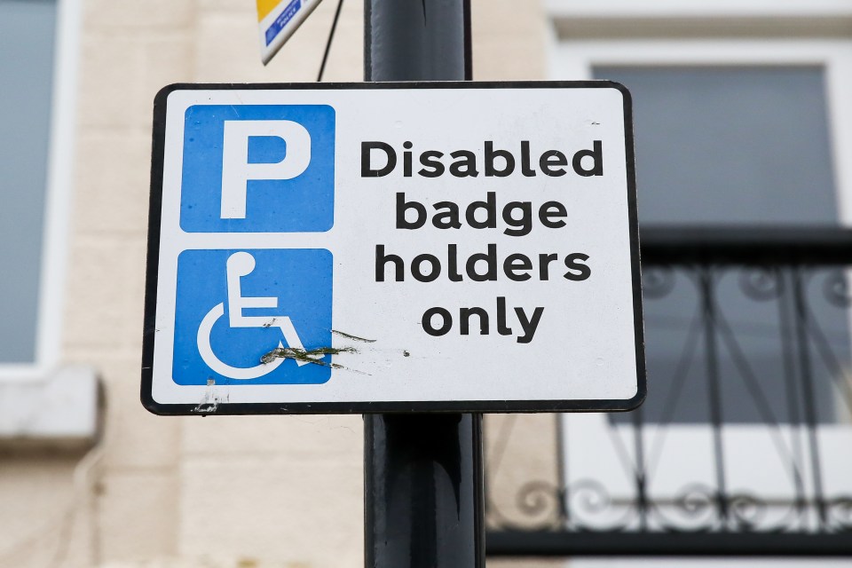 Disabled badge holders only parking sign.