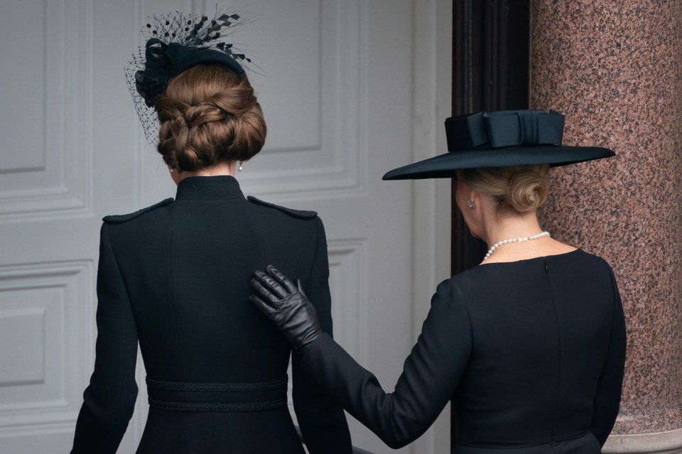 The Princess of Wales and the Duchess of Edinburgh leaving a balcony.