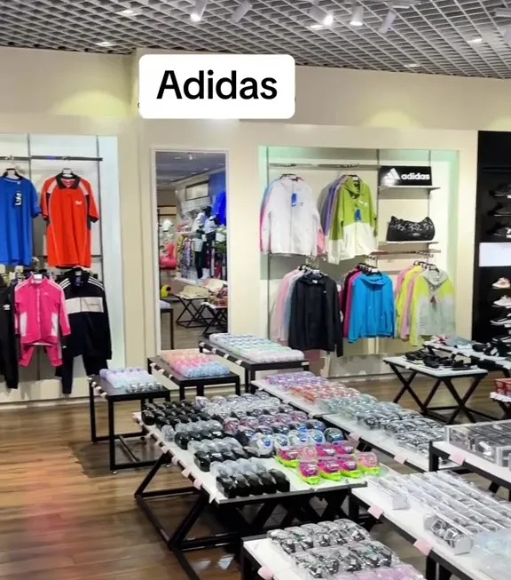 Adidas clothing and accessories displayed in a Pyongyang shopping center.