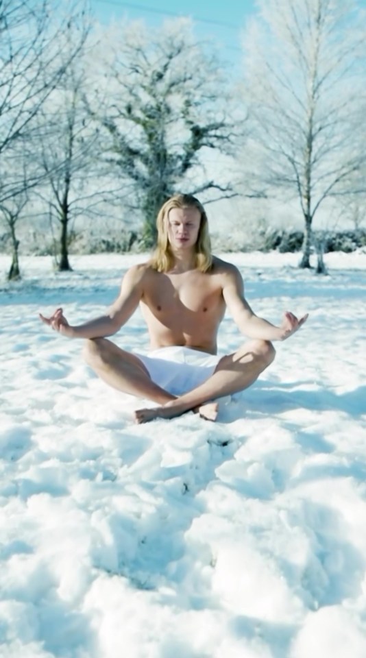 Man meditating in the snow.