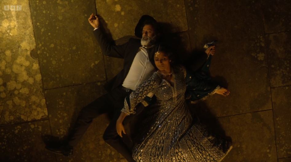 A man and woman lying on the ground.