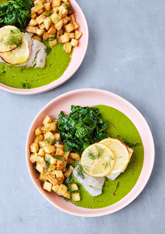 Two plates of fish with green sauce, potatoes, and spinach.