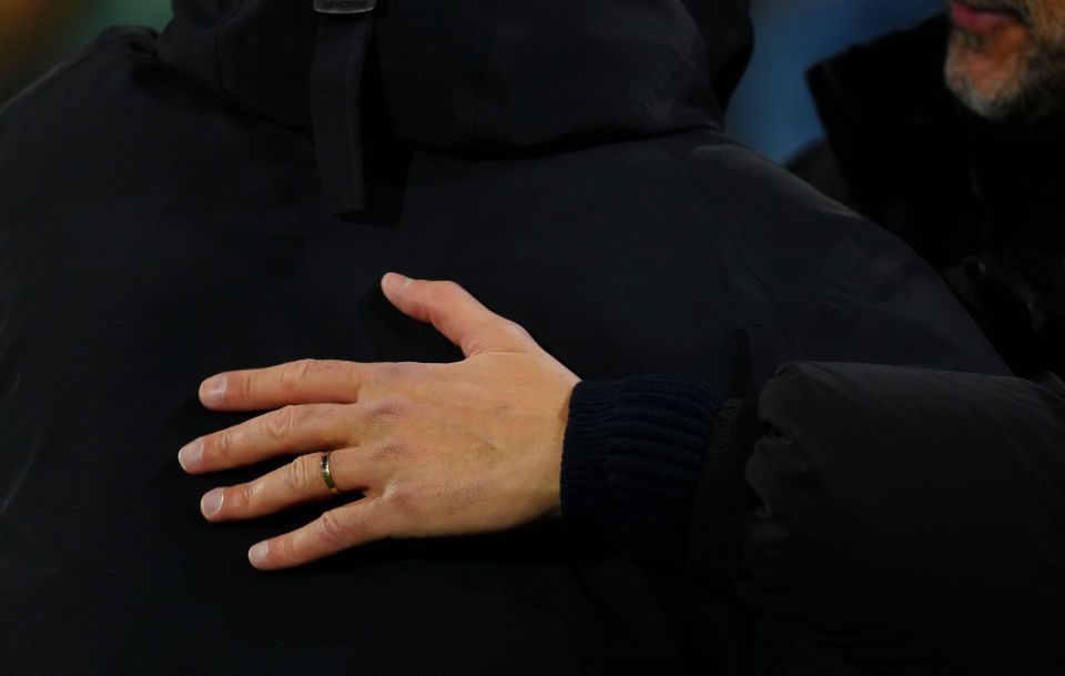 Close-up of Pep Guardiola's hand showing his wedding ring.