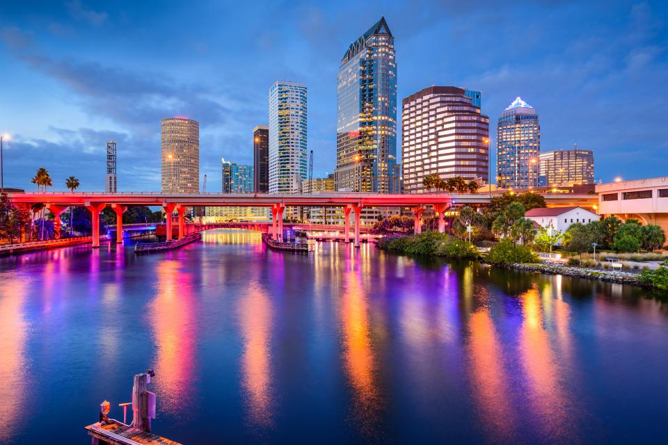 Tampa, Florida downtown skyline at night reflected in the Hillsborough River.