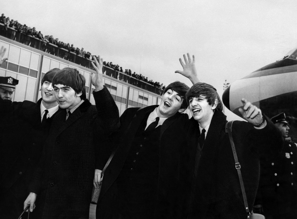 The Beatles arriving at JFK Airport, waving to fans.