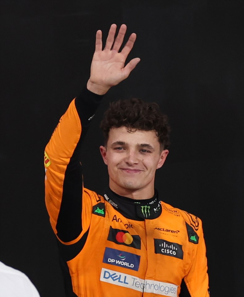 Lando Norris waving after winning the Formula One Abu Dhabi Grand Prix.