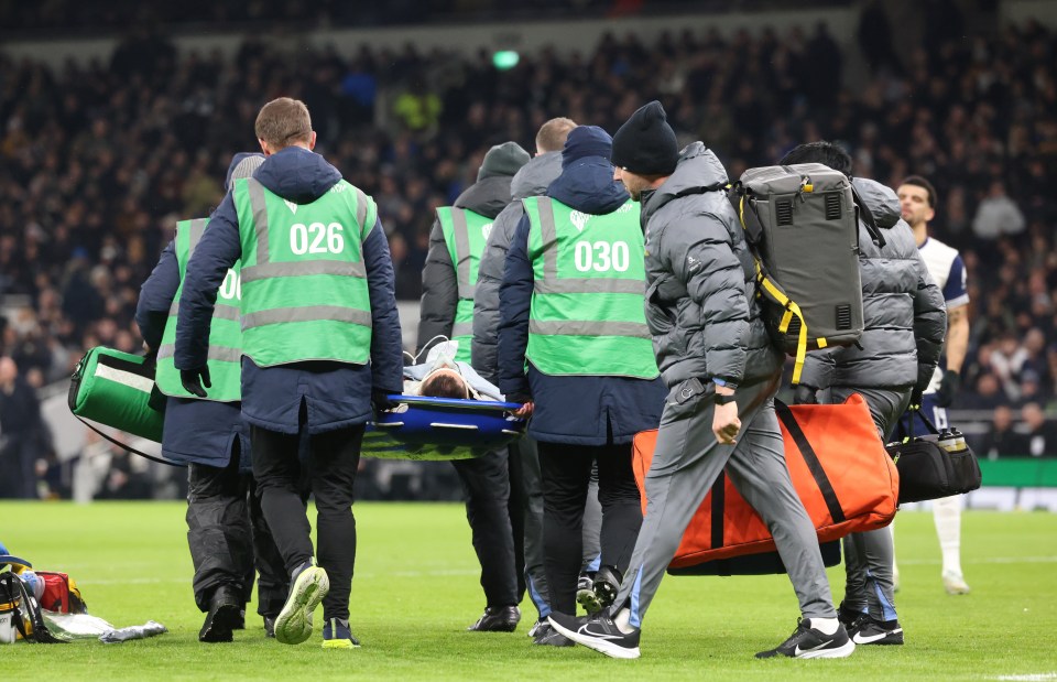 Rodrigo Bentancur of Tottenham Hotspur being carried off the pitch on a stretcher.