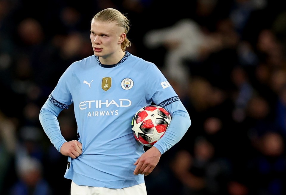 Erling Haaland of Manchester City holding a soccer ball.