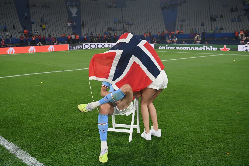 Erling Haaland and Isabel Johansen with the UEFA Champions League trophy.