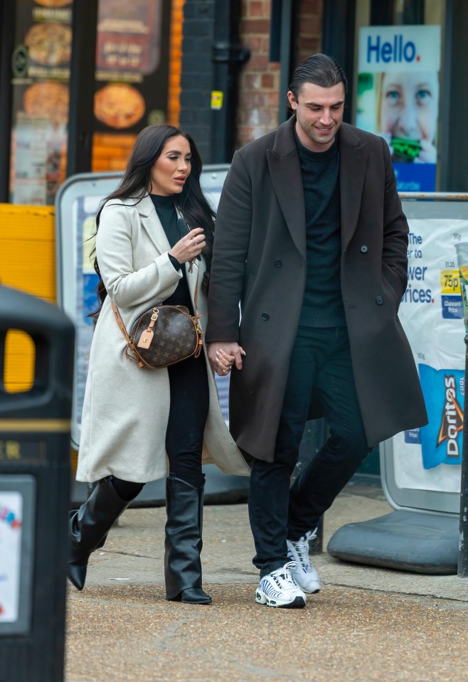 Former Love Island star Jack Fincham and a woman walking hand-in-hand.