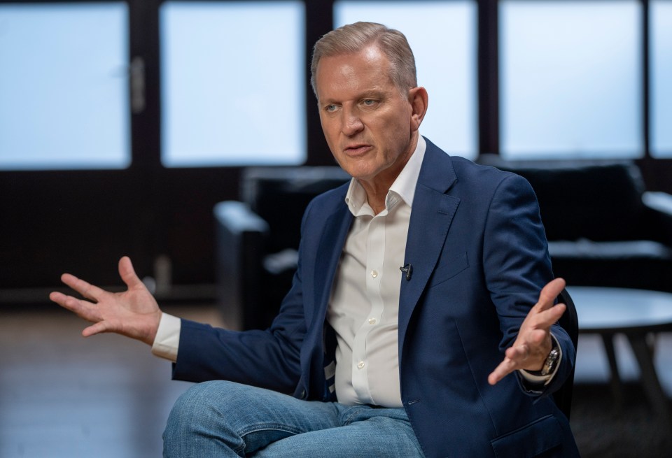 Jeremy Kyle in a blue blazer and jeans, gesturing during an interview.