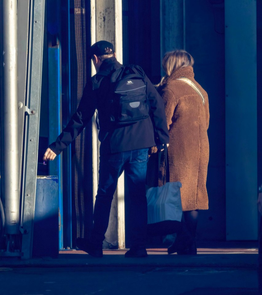 Peter Kay exiting a building.