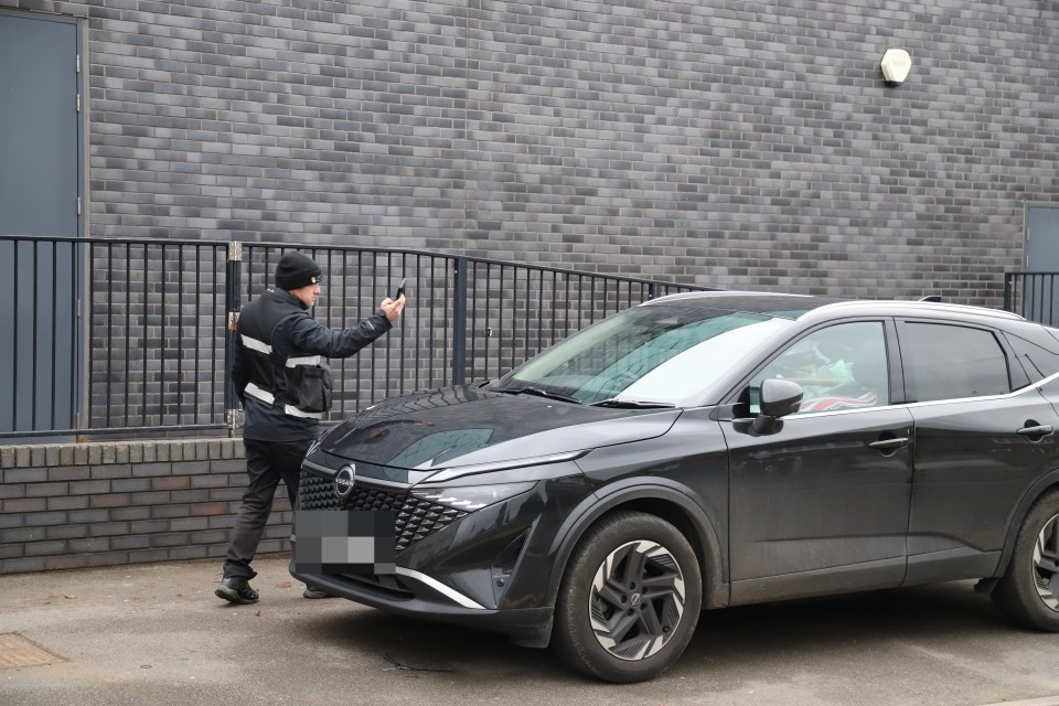 Parking attendant issuing a parking ticket to Katie Price's car.