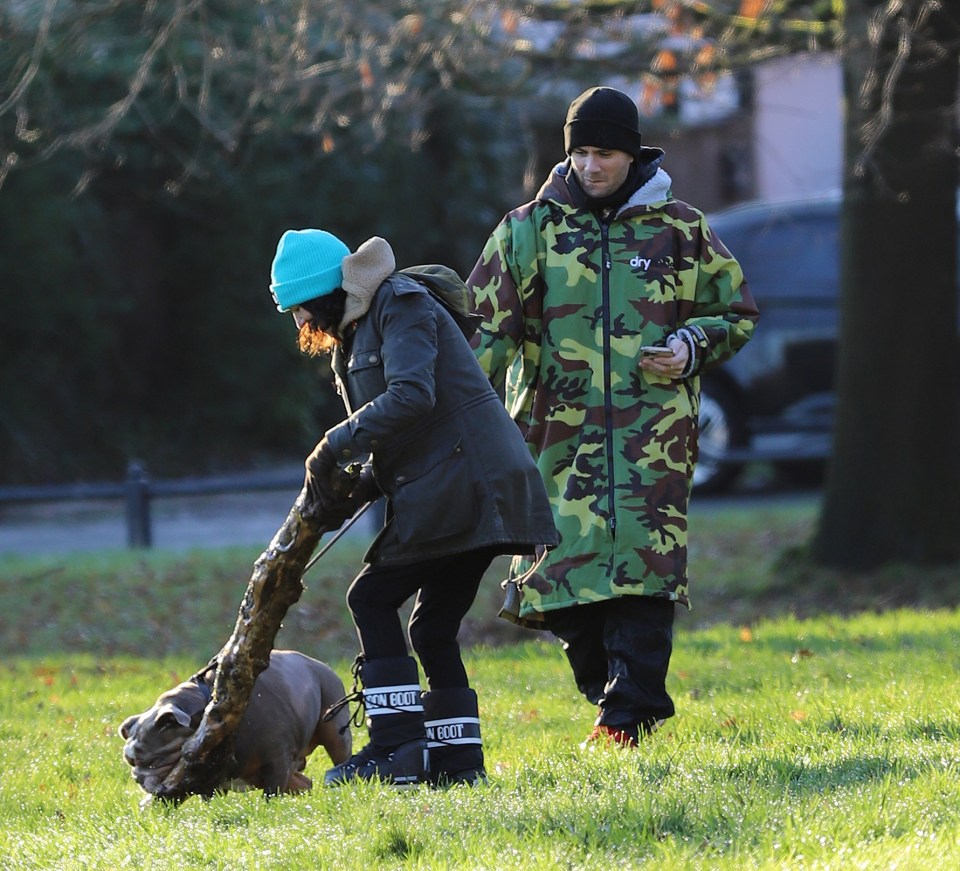 Max George walking his dog with his girlfriend and mother.