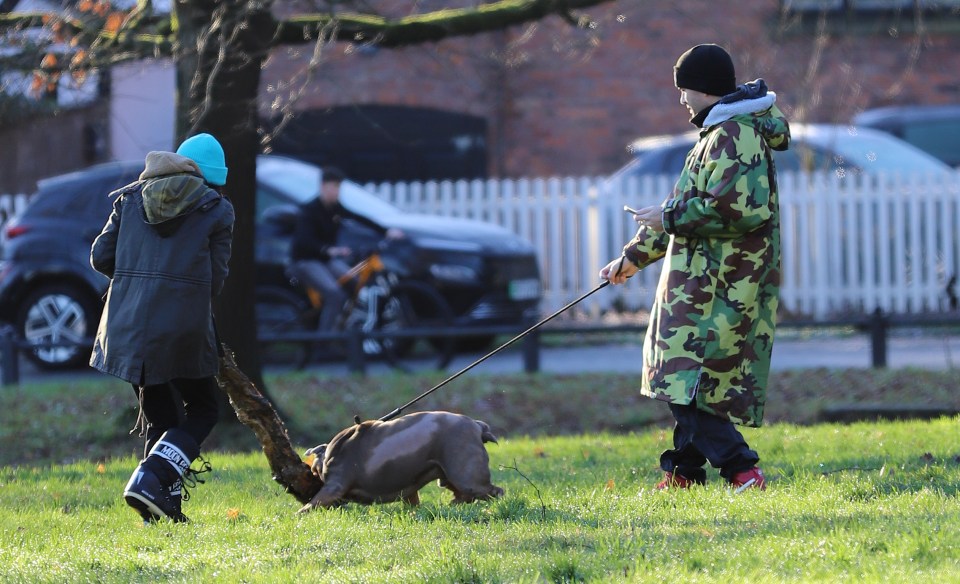 Max George walking his dog with his mother.