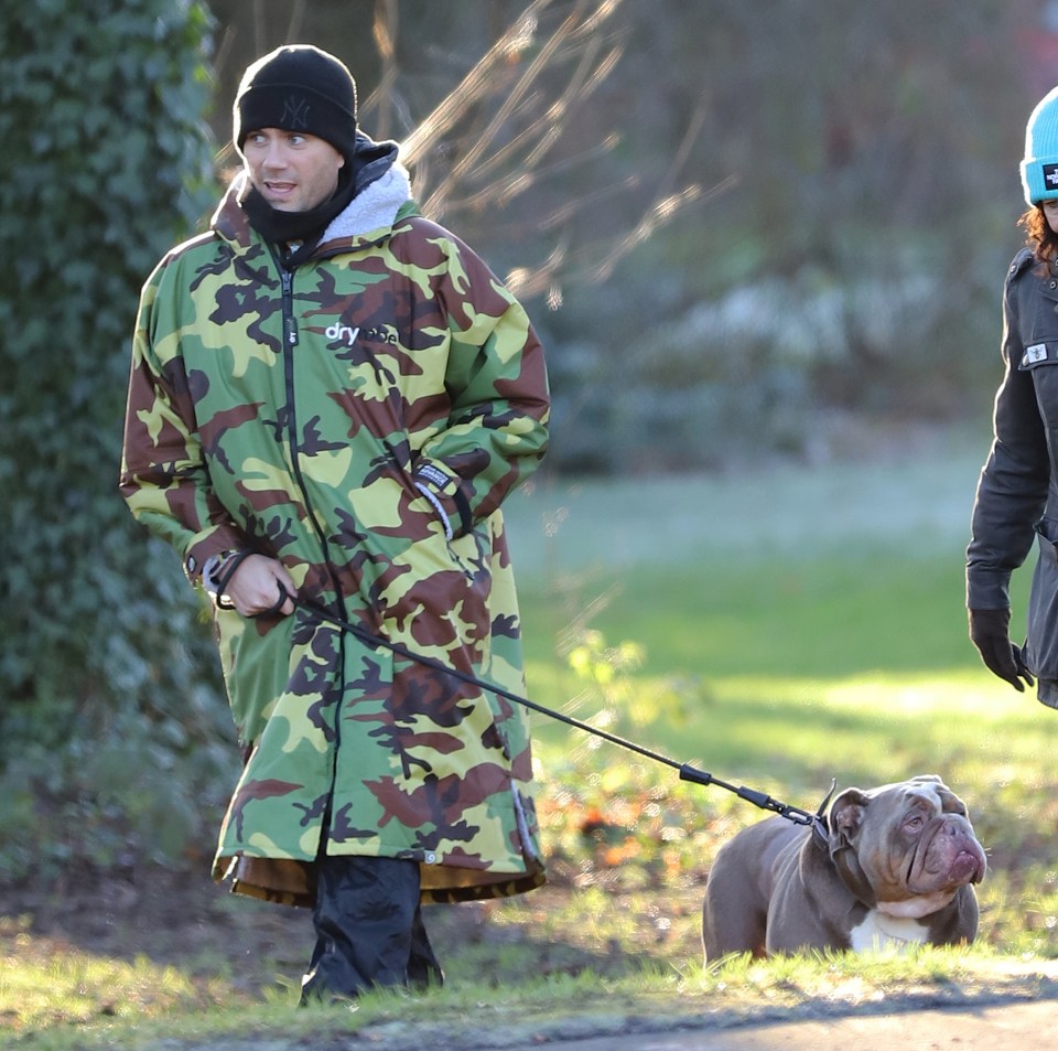 Max George walking his dog after a heart operation.