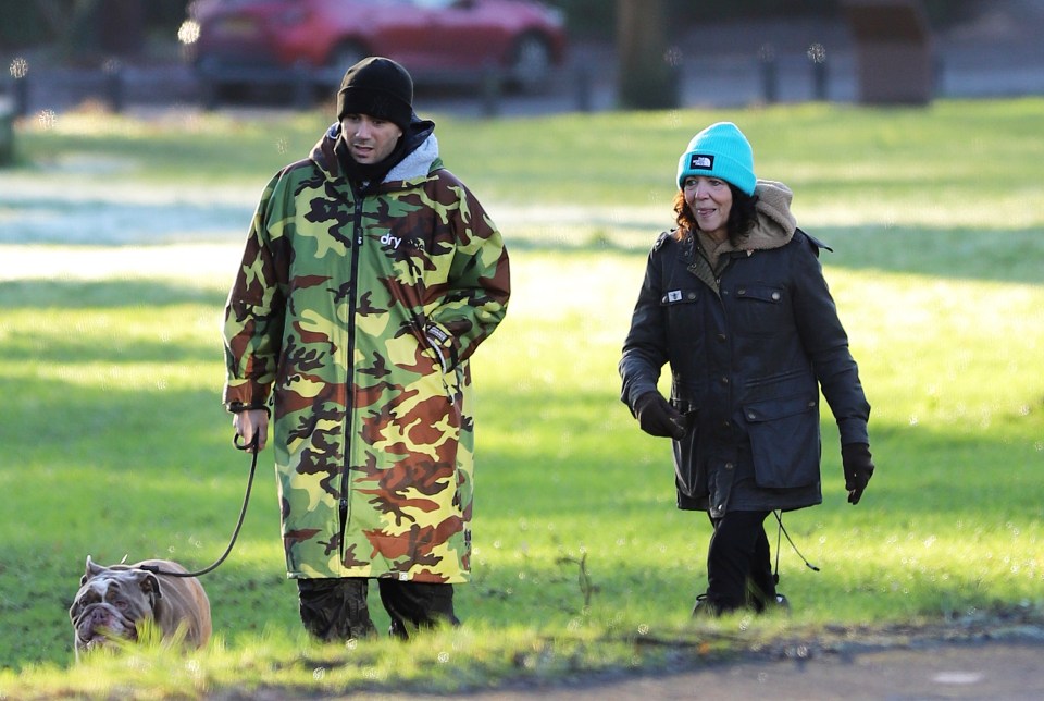 Max George walking a dog with his mother and girlfriend.