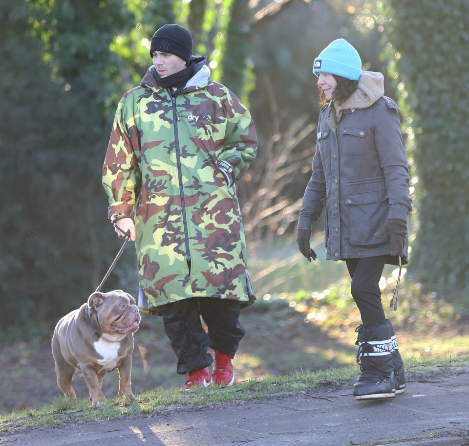 Max George walking his dog with his mother.