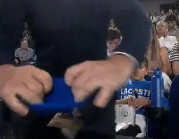 Novak Djokovic's family blocking TV cameras.