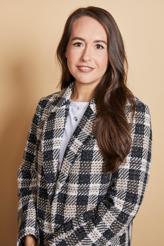 Woman in a black and white checkered blazer.