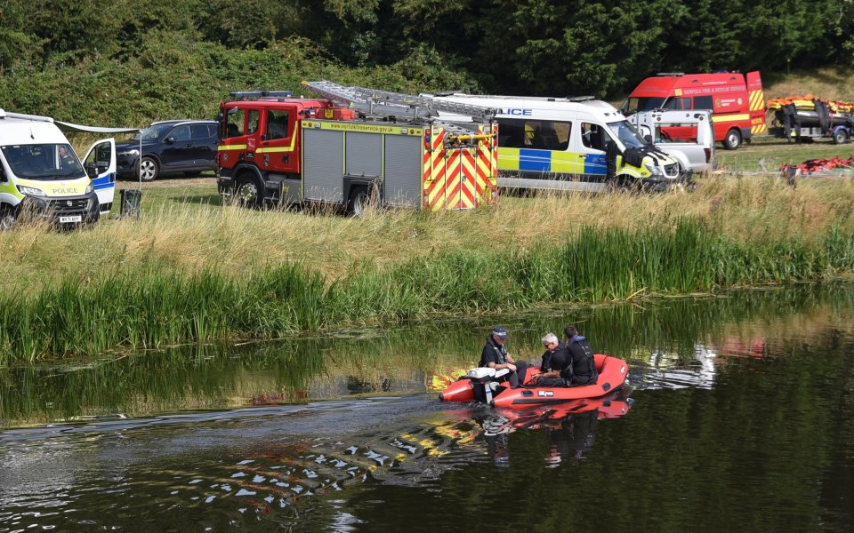 Emergency responders in a small boat at a search and recovery operation.