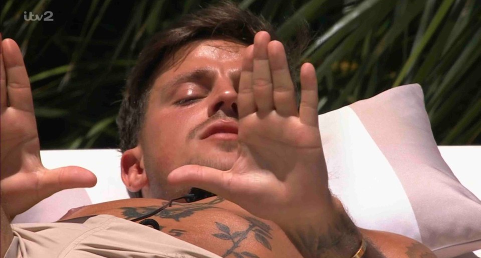 Luca Bish from Love Island All Stars lying down.