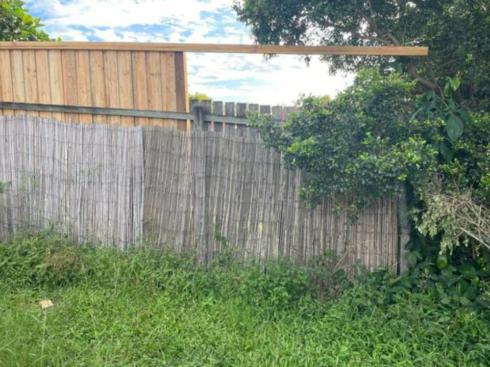 The new two-meter fence is incomplete and the neighbour claims she was not notified of the build