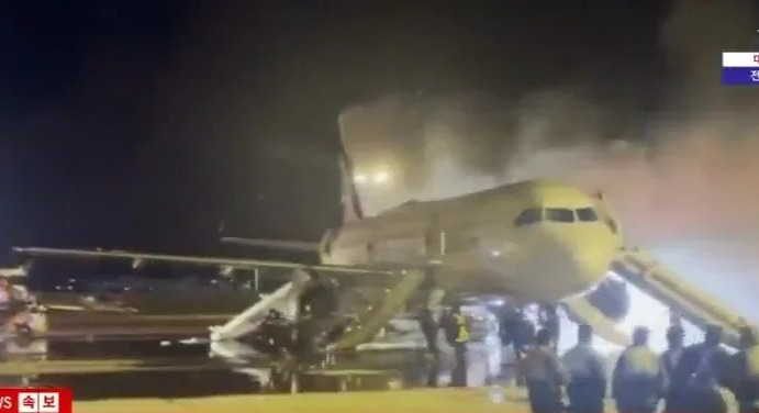 Airplane on fire at an airport.