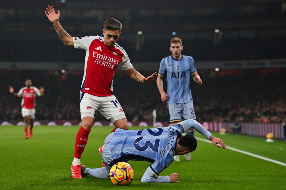 Arsenal's Leandro Trossard and Tottenham's Pedro Porro vying for the ball.