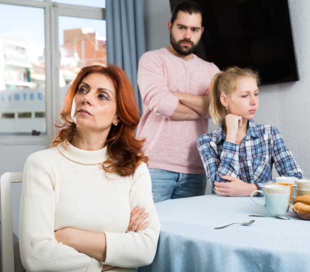 A serious family having a stressful conversation at home.