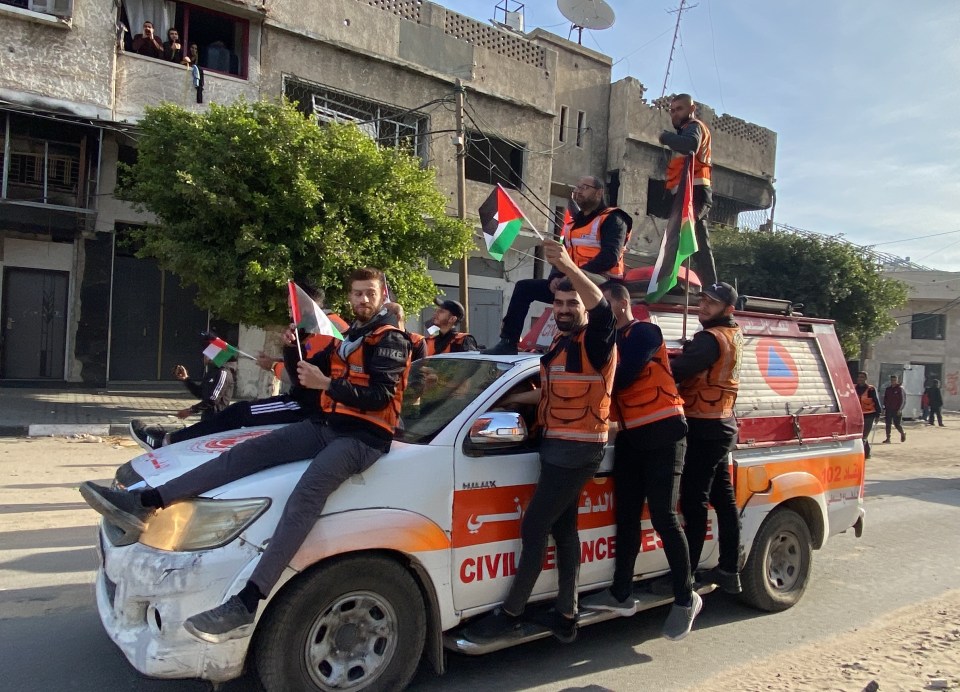 First aid and civil defense workers celebrating a ceasefire and prisoner exchange.